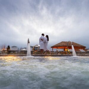 A couple stood next to the outdoor pool