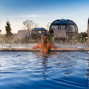 A woman sat in the outdoor pool