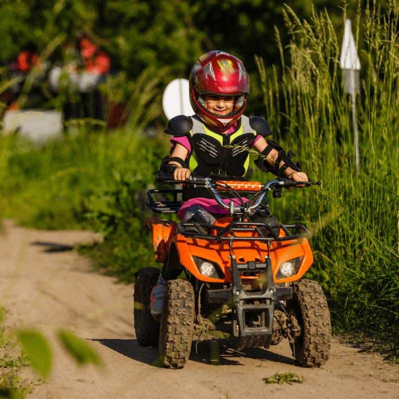 A child using a small quadbike