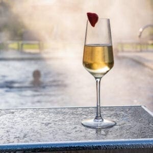 A champagne glass next to the Carden Park pool