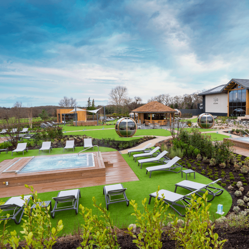 The outside spa areas with hot tubs and deck chairs